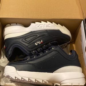 Fila kids size 4. Never worn. One shoe was a display so bottom is a little dingy